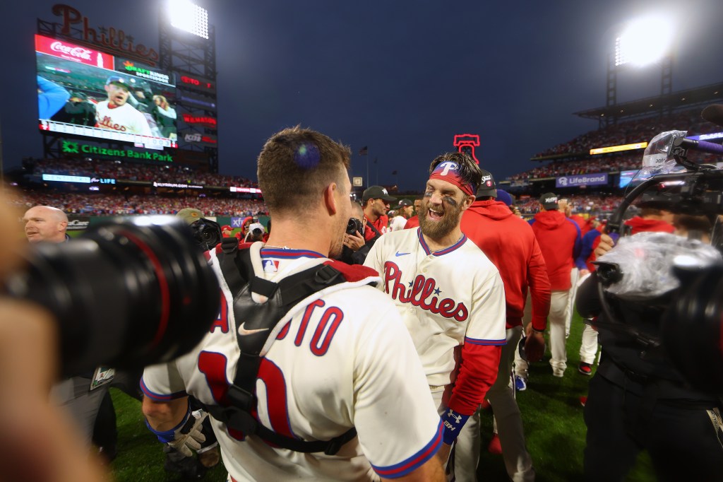 Philadelphia Phillies' Bryce Harper (3) reacts after Nick Castellanos (8)  hit a two-run home run during the first inning a spring training baseball  game against the Baltimore Orioles, Monday, March 28, 2022