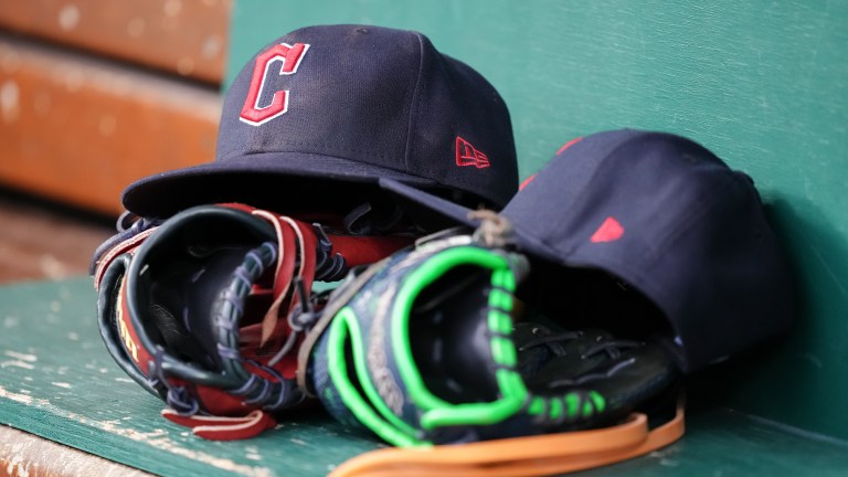 A detail view of Cleveland Guardians hats in the dugout during the game against the Cincinnati Reds at Great American Ball Park.