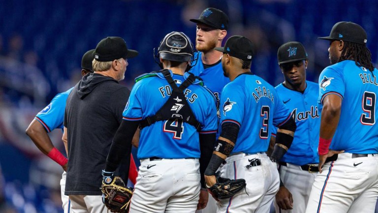 Miami Marlins pitching coach Mel Stottlemyre Jr. speaks with pitcher A.J. Puk (35) during the second inning of an MLB game on opening day against the Los Angeles Angels at LoanDepot Park.