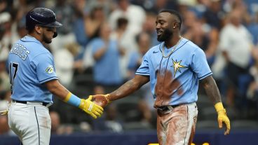 Randy Arozarena of the Tampa Bay Rays high-fives Isaac Paredes after stealing second, third and home plate in the first inning during the game between the New York Yankees and the Tampa Bay Rays at Tropicana Field.