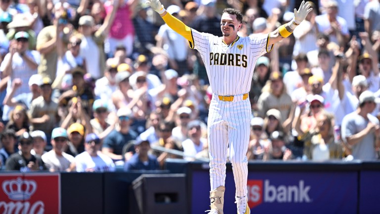 Jackson Merrill of the San Diego Padres celebrates after hitting a two-RBI triple against the Pittsburgh Pirates.