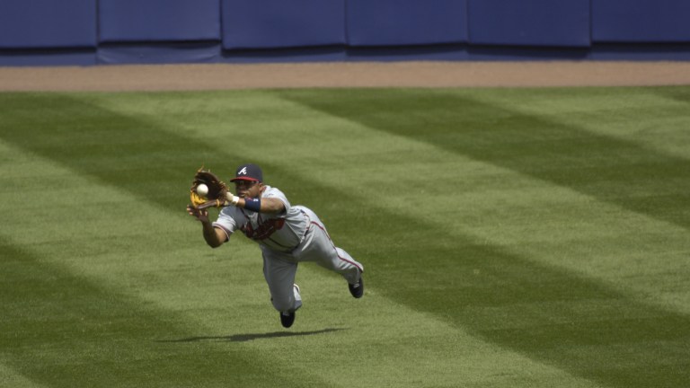 Atlanta Braves outfielder and Hall of Fame candidate Andruw Jones in action, making a diving catch.